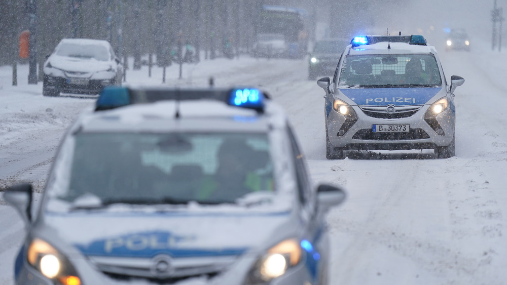 A road with snow and cars