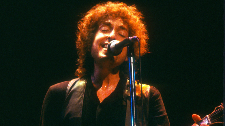 Bob Dylan singing into microphone