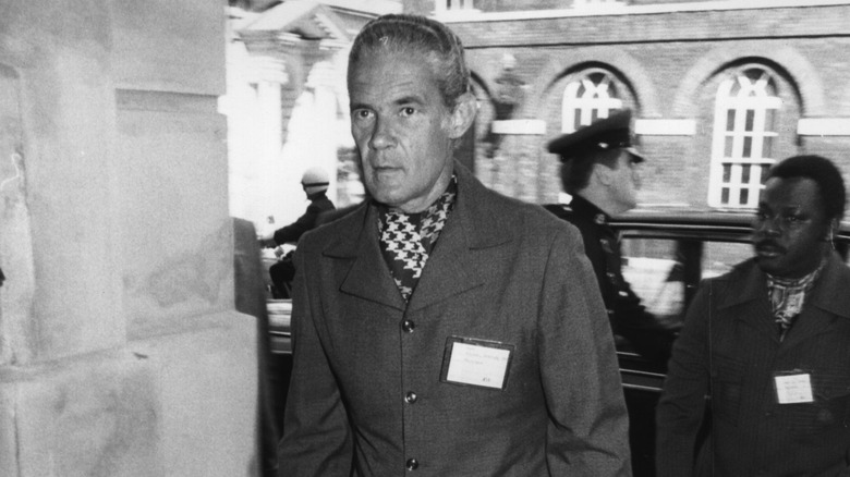 Michael Manley in coat and scarf