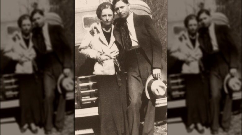 Bonnie and Clyde together in front of car