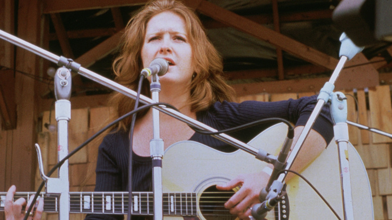 Bonnie Raitt playing guitar at event