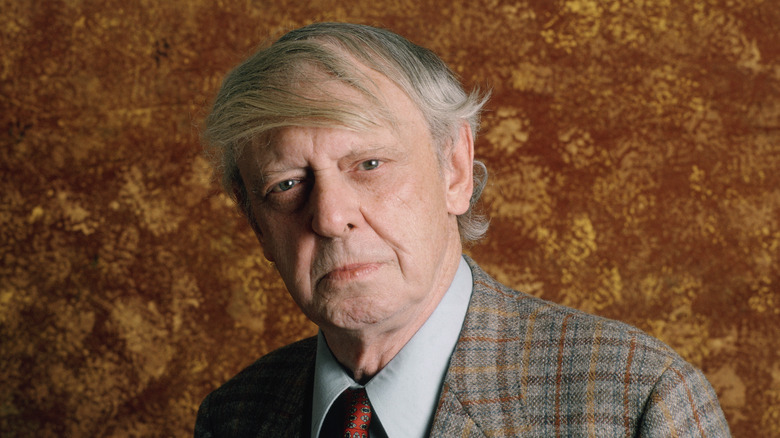 Anthony Burgess in checked jacket with combover