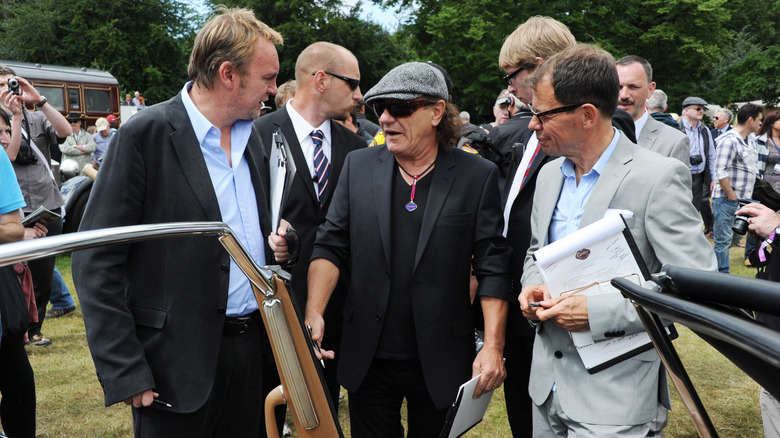 Brian Johnson judging cars in England