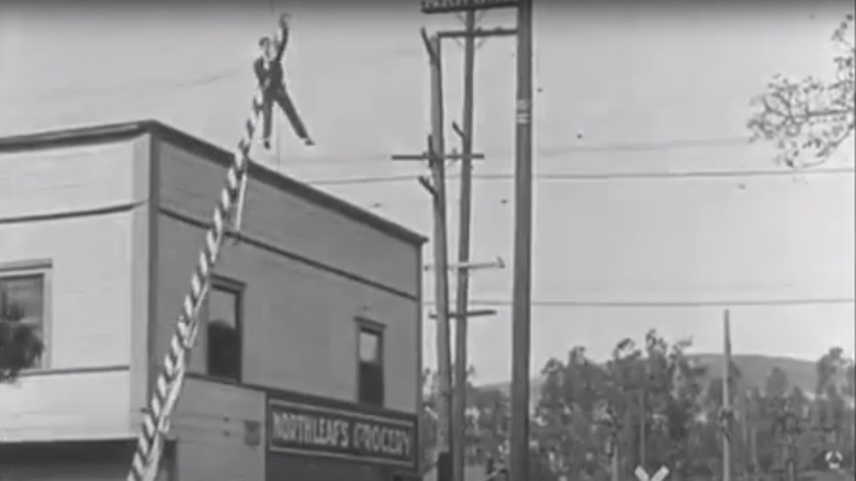 Keaton rides a traffic gate into a moving car