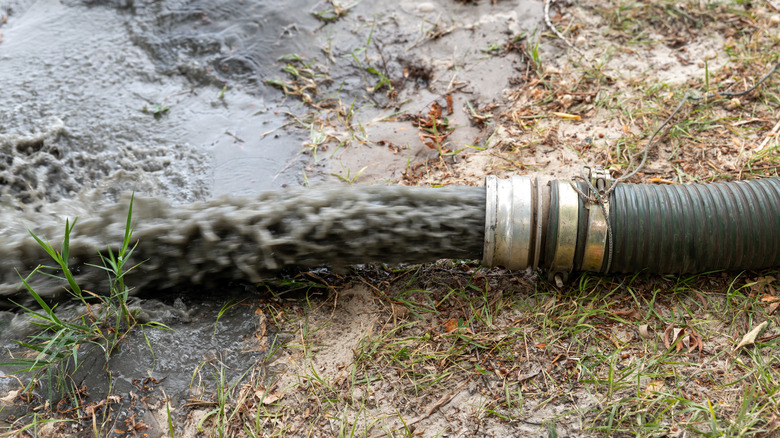 waste water being pumped out of tube into ground