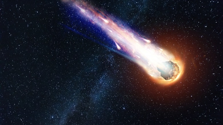 burning asteroid in starry sky