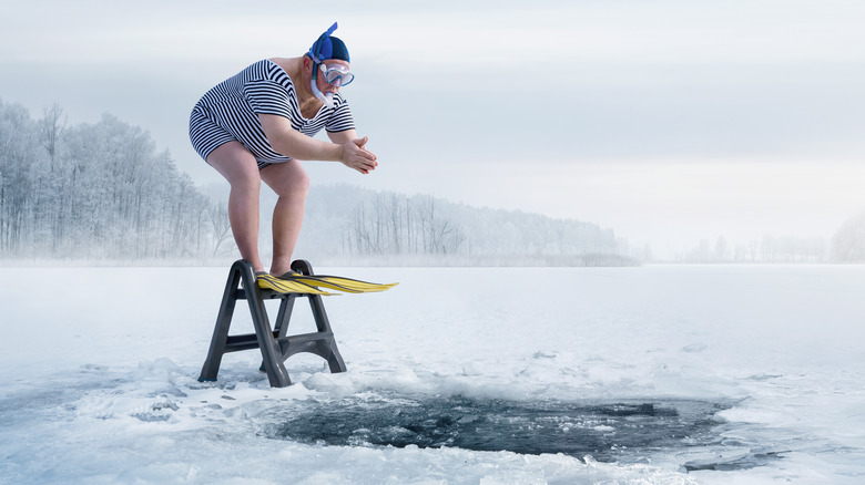 Man diving into frozen lake
