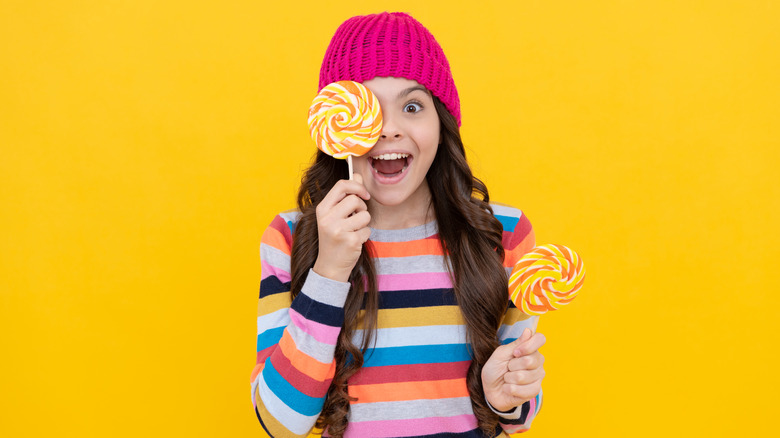 a child enjoying lollipops