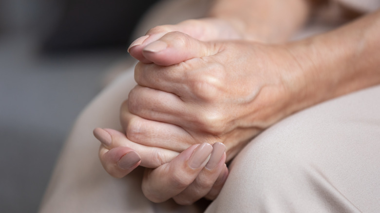 woman's hands clasped together