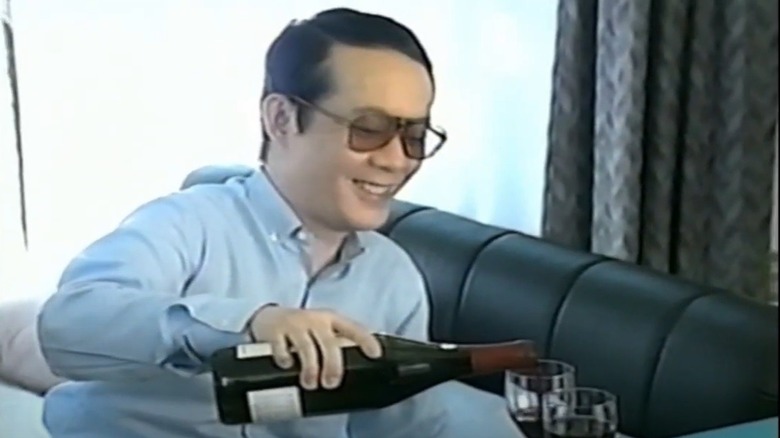 Issei Sagawa pouring wine