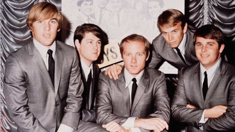 Dennis Wilson posing with his bandmates
