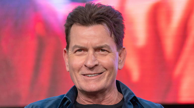 Charlie Sheen smiling blue shirt