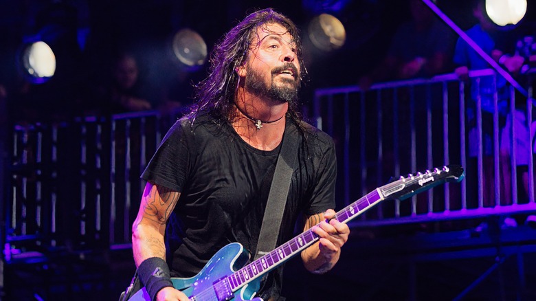 Dave Grohl black shirt playing guitar onstage