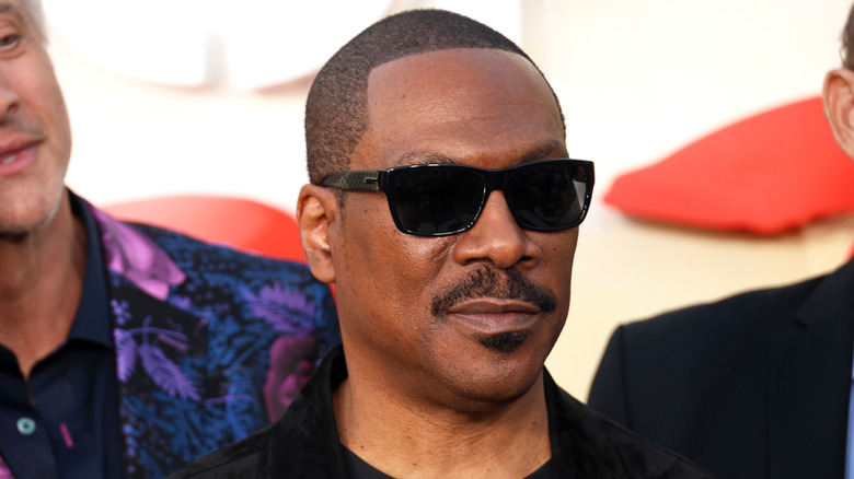 Eddie Murphy black shirt sunglasses at event