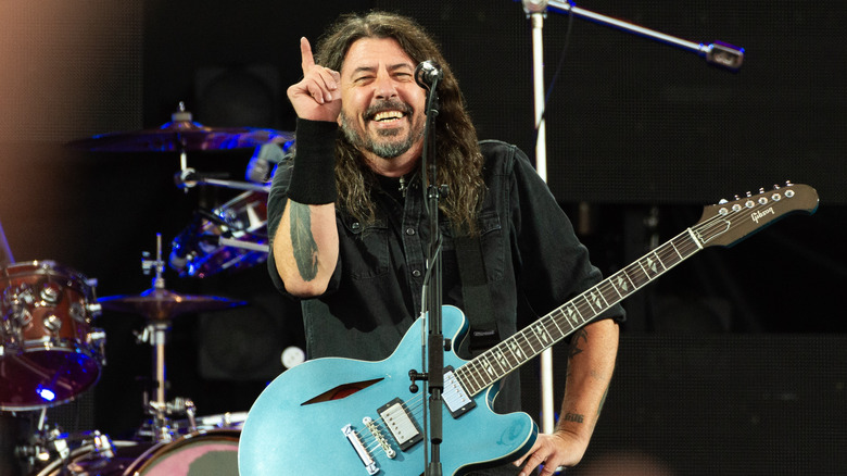 Dave Grohl smiling pointing finger guitar onstage