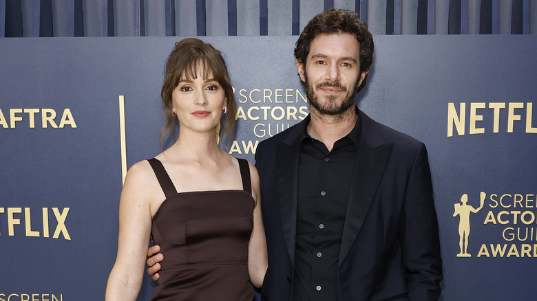 Leighton Meester and Adam Brody smiling at event