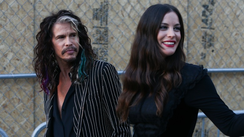 Steven Tyler and Liv Tyler smiling outdoors