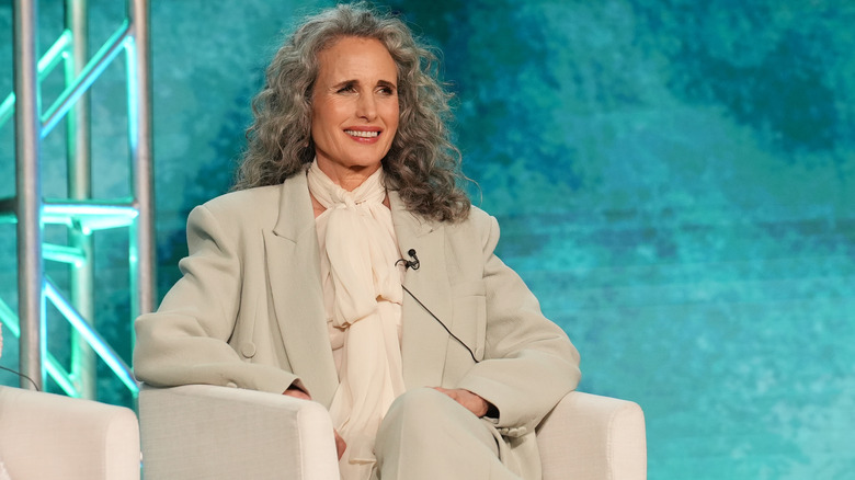 Andie MacDowell sitting on stage