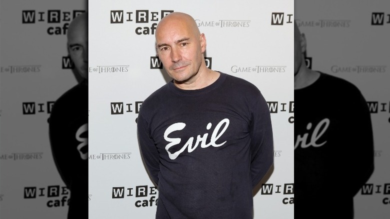 Grant Morrison with a shirt reading "evil"