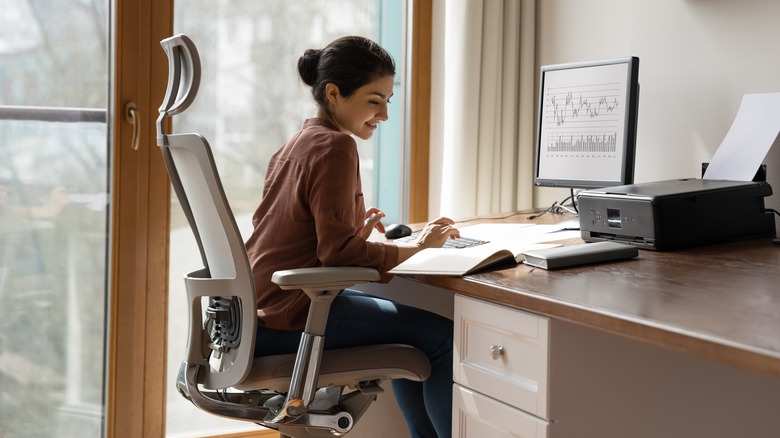 Person sitting at desk in modern office chair