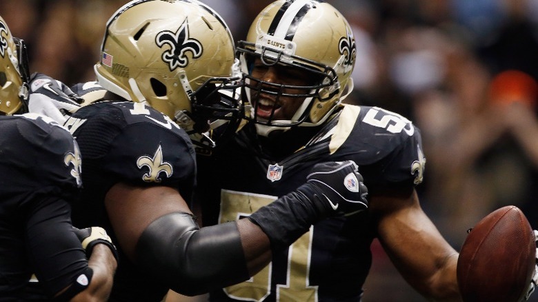 Saints players holding ball