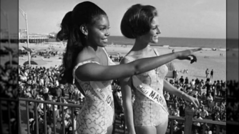 Cheryl Browne pointing at the beach