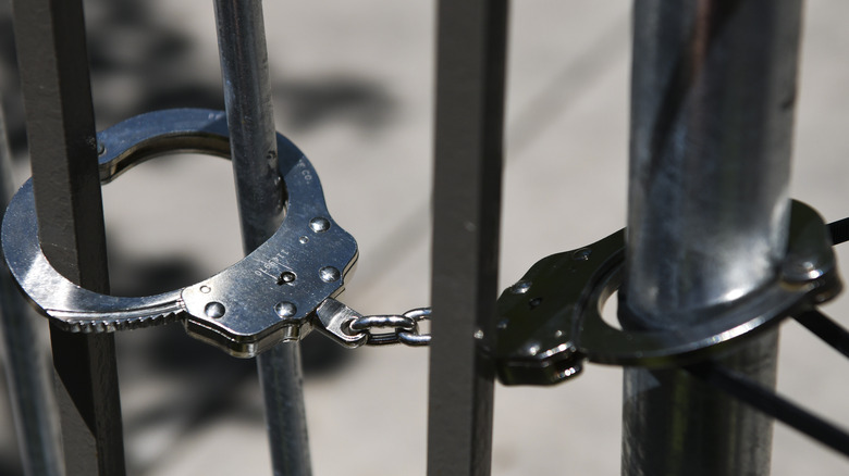 Handcuffs locked to bars