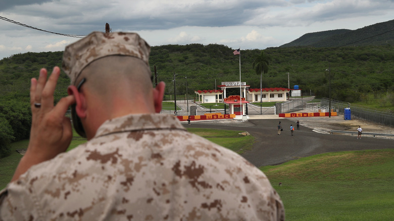 Marine looking over gitmo gate