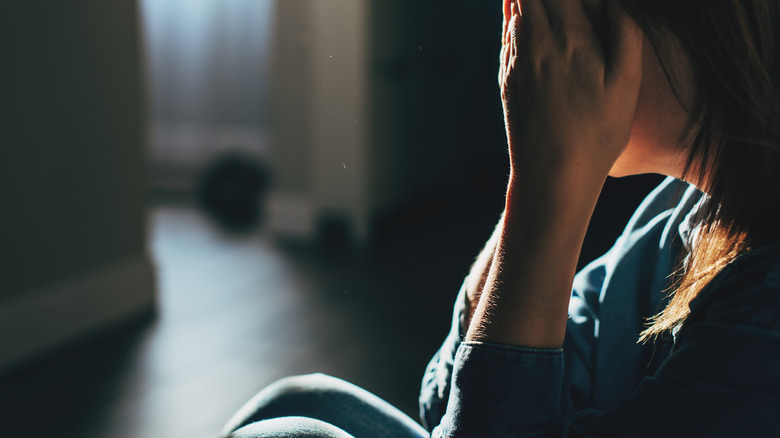 Grieving woman holding face