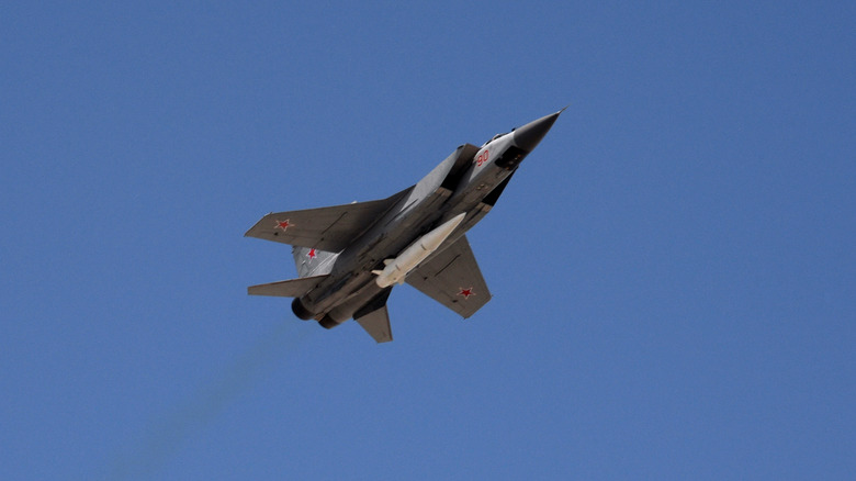 Flying fighter jet with missile underneath