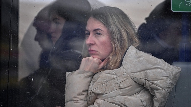 Woman riding train looking out window