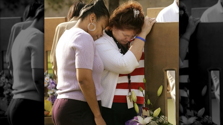 People crying at memorial