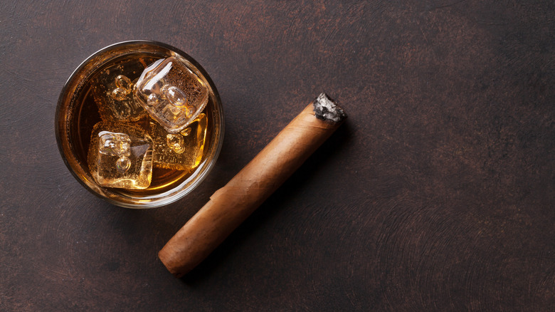 glass of whiskey with a cigar