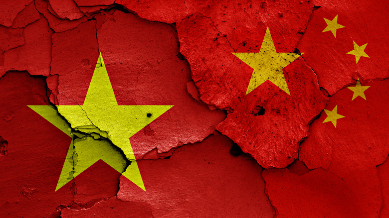 Cracked Chinese and Vietnamese flags