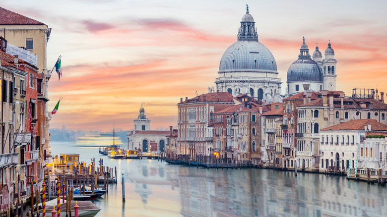 Venice with canal in the foreground at sunset