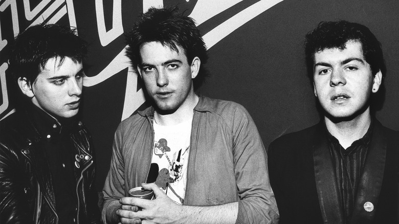 The Cure's Simon Gallop, Robert Smith, and Lol Tolhurst posing for photo in 1980