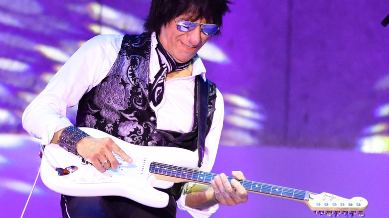 Jeff Beck playing white guitar sunglasses