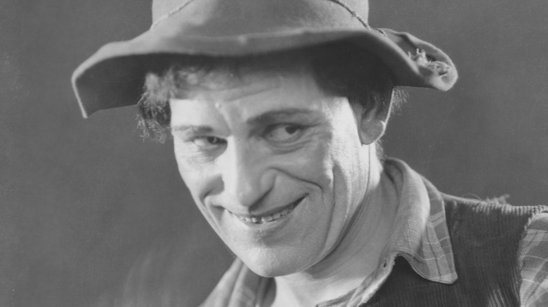 Lon Chaney smiling wearing hat