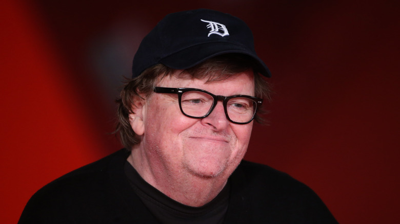 Michael moore smiling in baseball cap