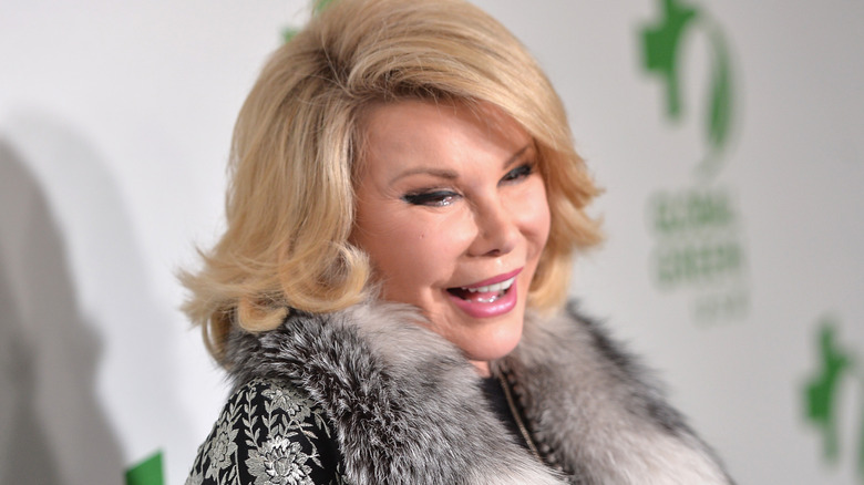 Joan Rivers smiling fur jacket at event