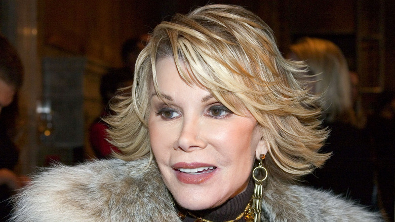 Joan Rivers smiling fur jacket at event