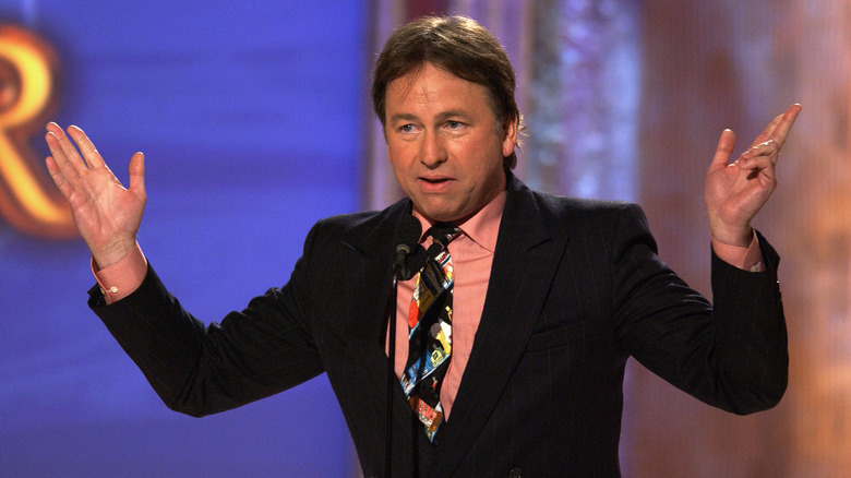 John Ritter suit mic hands raised on stage