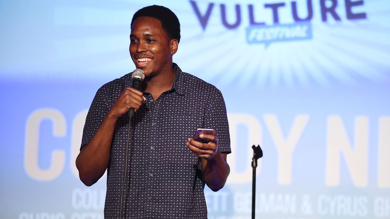 Kevin Barnett performing holding phone Vulture festival