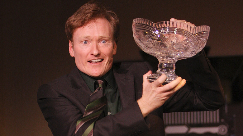 Conan O'Brien holding award