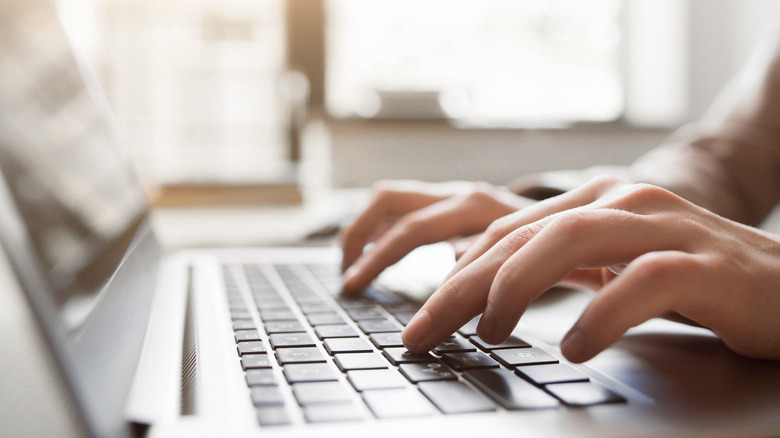 person typing on computer