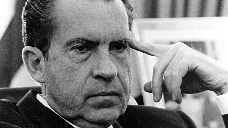 President Richard Nixon touching face