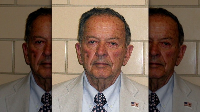 Ted Stevens stands for his mugshot