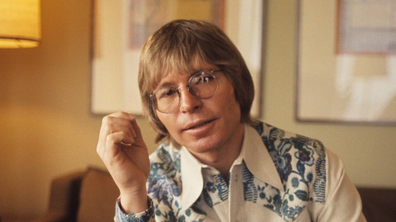 John Denver wearing round glasses