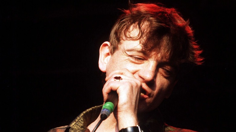 Mark E Smith on stage with The Fall in 1991