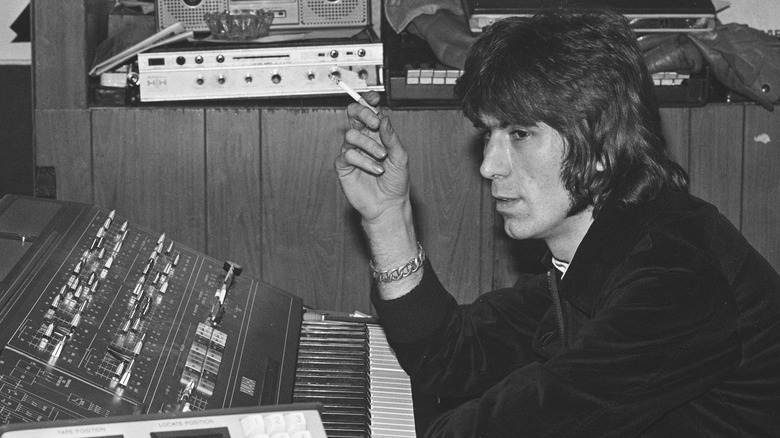 Cozy Powell smoking cigarette at soundboard